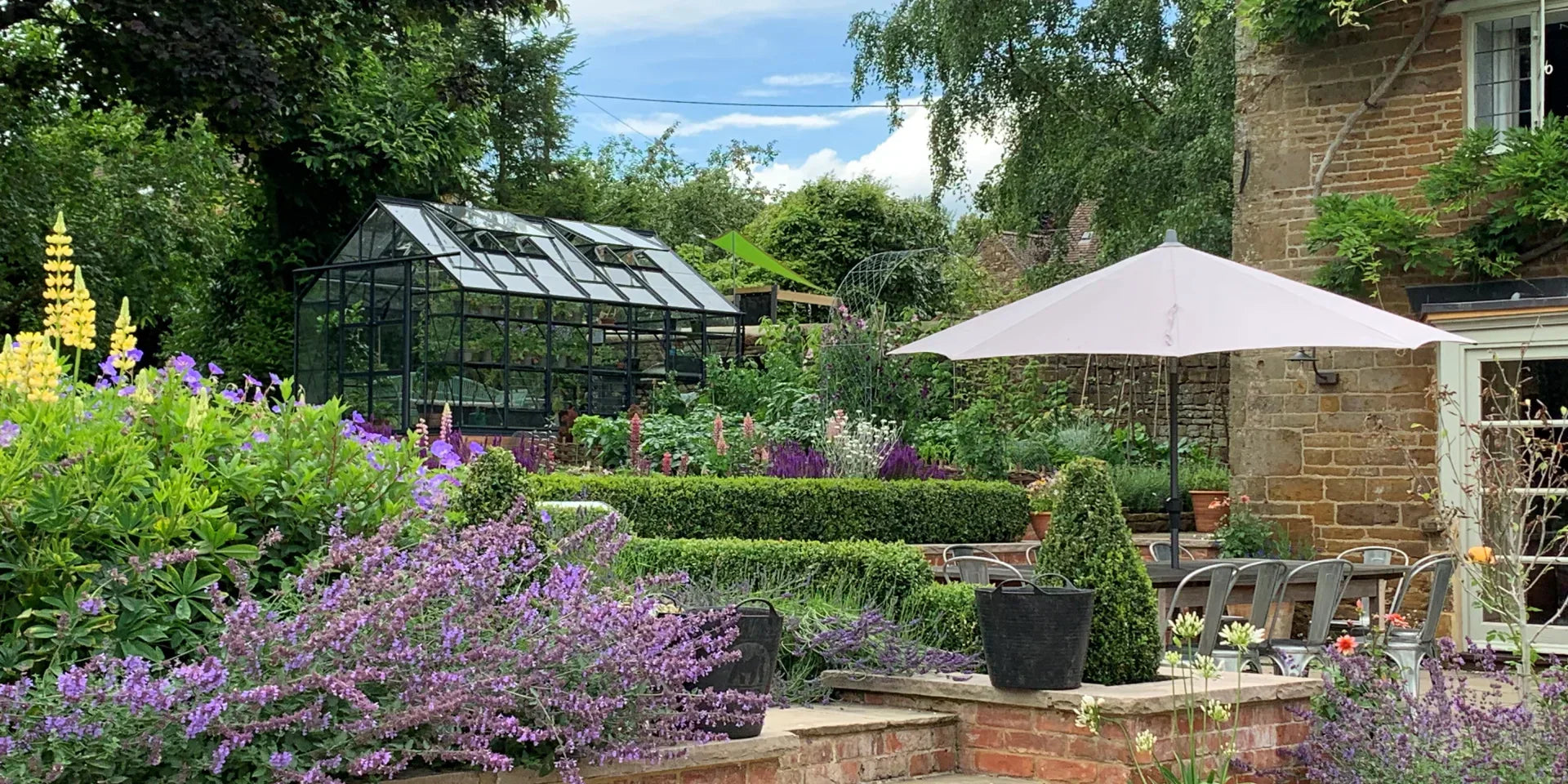 How should you prepare your garden for hot and dry weather?