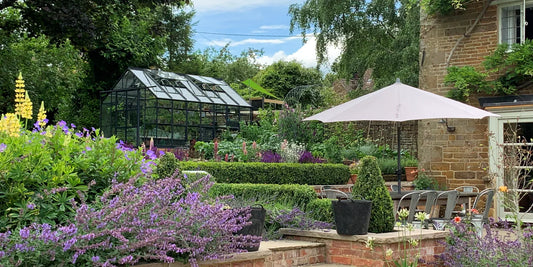 How should you prepare your garden for hot and dry weather?