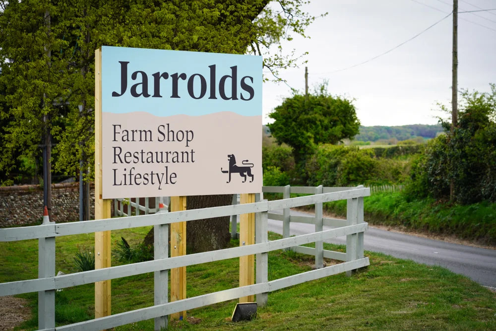 Jarrolds Farm shop sign behind a painted white fence
