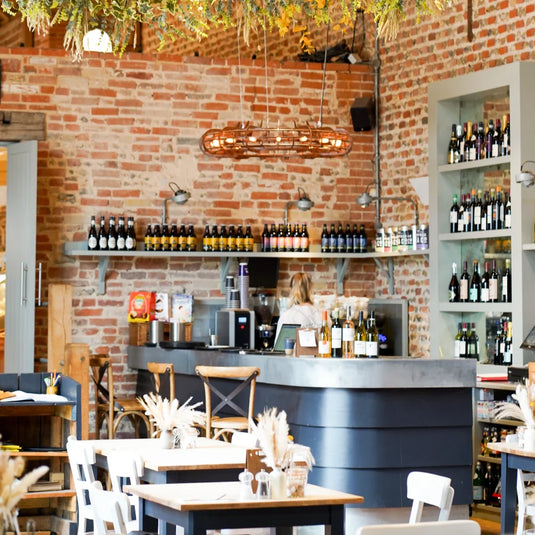A bar surrounded by wine and beer bottles