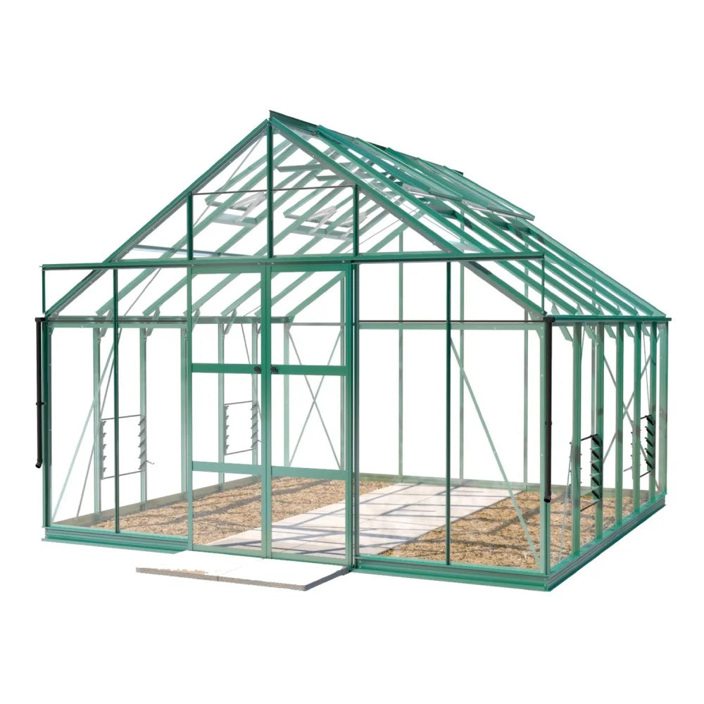 A green metal-framed Rhino Greenhouse with transparent panels stands on a sandy base, featuring multiple windows and a central door, designed for gardening. The background is plain white.