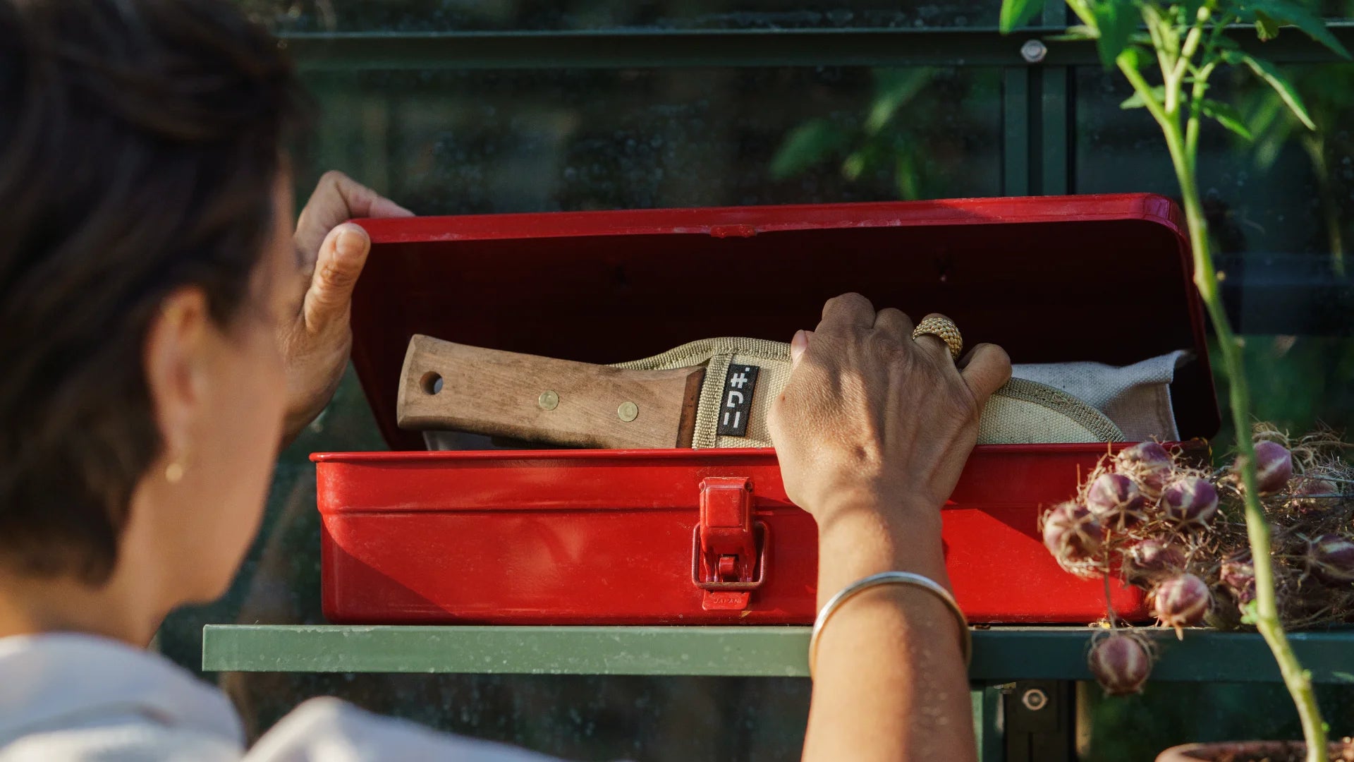 Lady reaching into her red storage box
